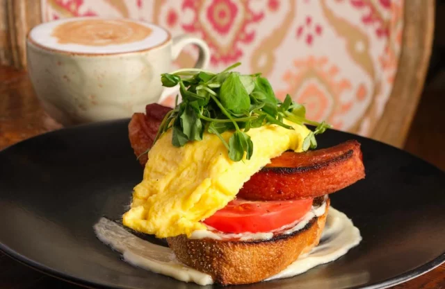 Meet the ultimate weekend indulgence: our BELT. Thick-cut steak bacon, soft scrambled eggs, arugula, tomato parmesan, lemon aioli, and sourdough toast — crowned with a poached farm egg. Who’s hungry?! We’ll see you for brunch!